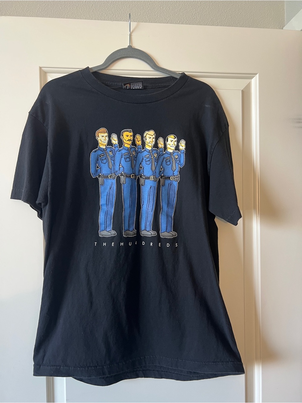 The Hundreds Men’s Black Tee with Blue Police Cartoon Graphic